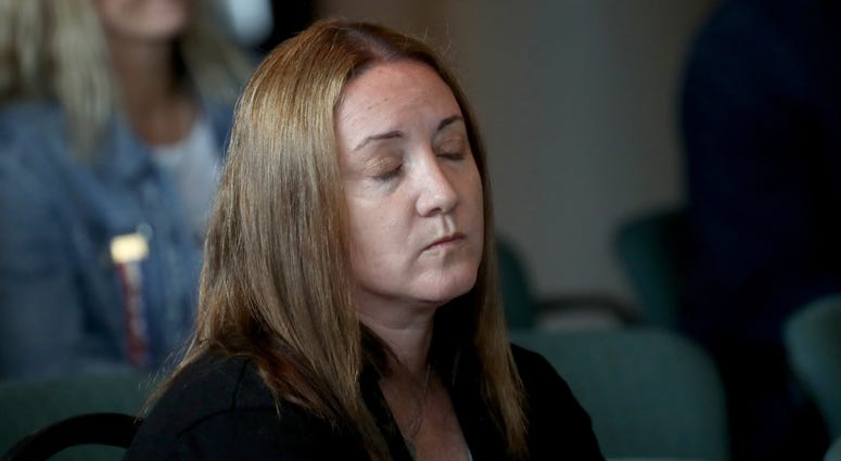 Lori Alhadeff, the mother of shooting victim Alyssa watches videos from the school shooting during the Marjory Stoneman Douglas High School Public Safety Commission meeting Thursday Nov 15, 2018 in Sunrise, Fla. Lori Alhadeff