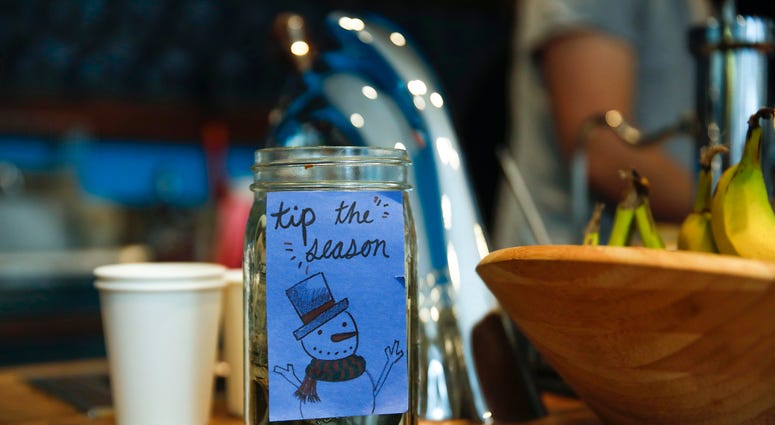 A tip jar at a Dollop coffee shop in the Streeterville neighborhood in Chicago on Thursday, Nov. 29, 2018. Tip Jar
