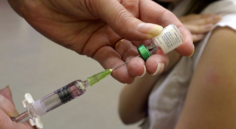 A measles vaccination being administered to a young girl on April 25, 2013. Measles Vaccine