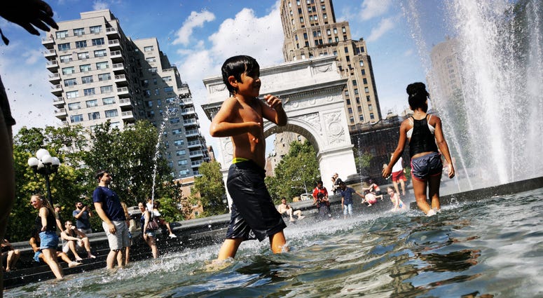 People cool off at a fountain in New York City, the United States, July 20, 2019. Heat wave New York City