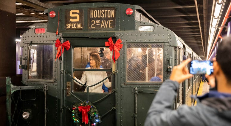People take a ride in a vintage subway car during Holiday Nostalgia Rides in New York's subway, the United States, Dec. 8, 2019. Holiday Train Ride