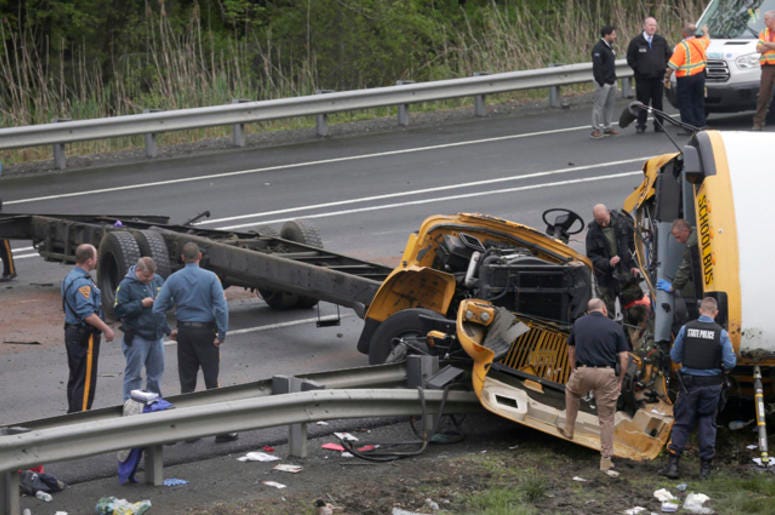 Emergency personnel work at the scene of a school bus and dump truck collision, injuring multiple people, on Interstate 80 in Mount Olive, N.J., Thursday, May 17, 2018. Deadly New Jersey School Bus Crash
