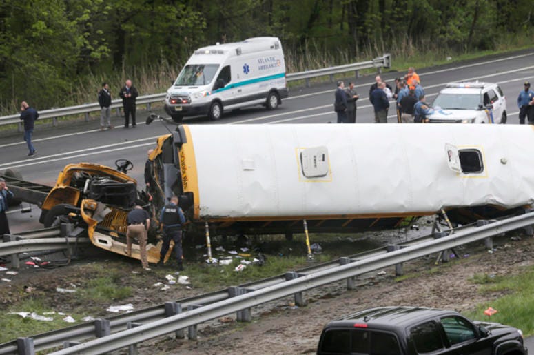Emergency personnel work at the scene of a school bus and dump truck collision, injuring multiple people, on Interstate 80 in Mount Olive, N.J., Thursday, May 17, 2018. Deadly New Jersey School Bus Crash