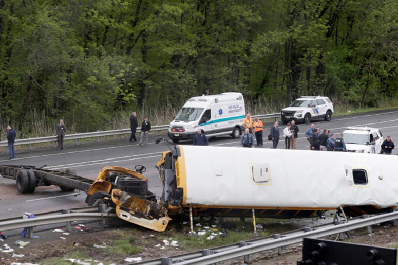 Emergency personnel work at the scene of a school bus and dump truck collision, injuring multiple people, on Interstate 80 in Mount Olive, N.J., Thursday, May 17, 2018. Deadly New Jersey School Bus Crash