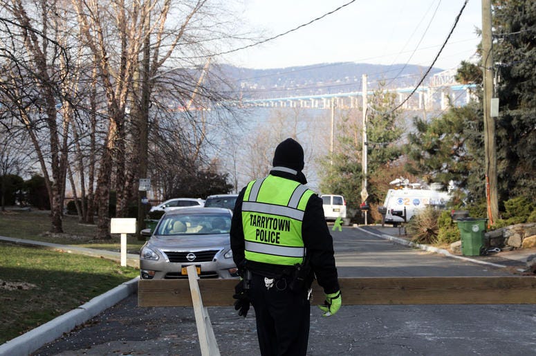 A police officer stands on Van Wart Avenue as people head to the Riverwalk to get a view of the demolition of the eastern portion of the Tappan Zee Bridge Jan. 15, 2019 in Tarrytown. Tappan Zee Demolition