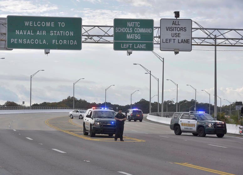 Police vehicles block the entrance to the Pensacola Air Base, Friday, Dec. 6, 2019 in Pensacola, Fla. Pensacola shooting