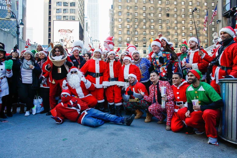 People pose as they take part during the annual New York SantaCon on December 8, 2018 in New York City. SantaCon is in it's 20th year in New York City. SantaCon 2018
