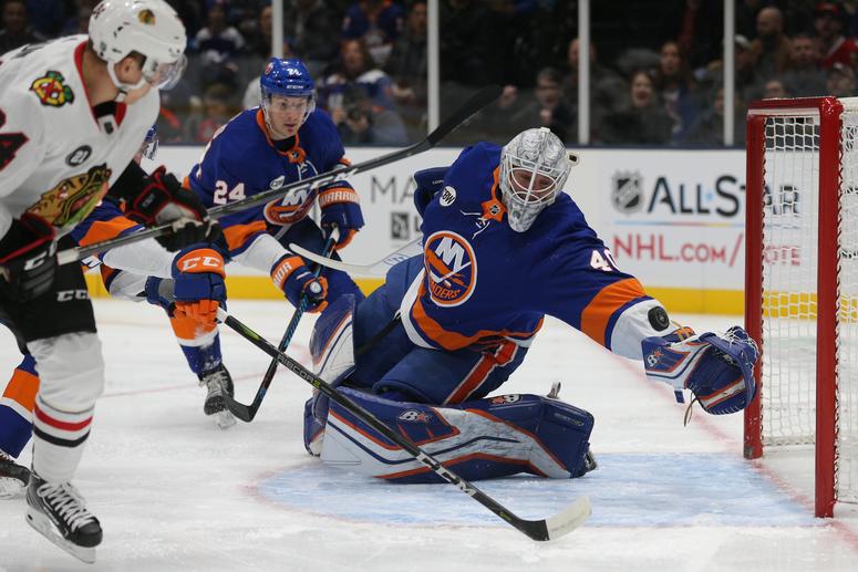 Chicago Blackhawks center Dominik Kahun (24) scores a goal against New York Islanders goalie Robin Lehner (40) during the first period at Nassau Veterans Memorial Coliseum. New York Islanders