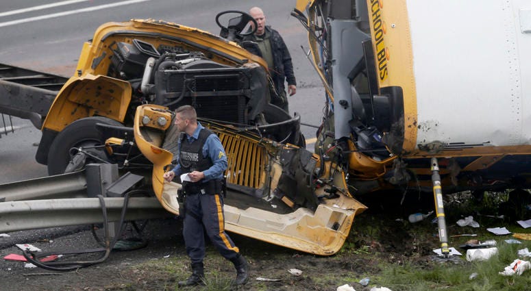 Emergency personnel work at the scene of a school bus and dump truck collision, injuring multiple people, on Interstate 80 in Mount Olive, N.J., Thursday, May 17, 2018. Deadly New Jersey School Bus Crash