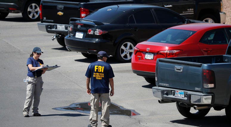 Members of the FBI evidence response team investigate the scene of a mass shooting at a shopping complex Sunday, Aug. 4, 2019, in El Paso, Texas. El Paso shooting