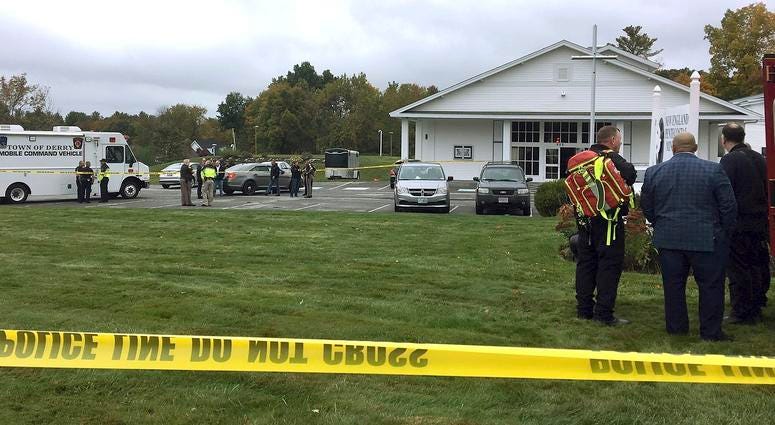 In this photo provided by WMUR-TV, police stand outside the New England Pentecostal Church after reports of a shooting on Saturday, Oct. 12, 2019, in Pelham, N.H. New Hampshire church shooting