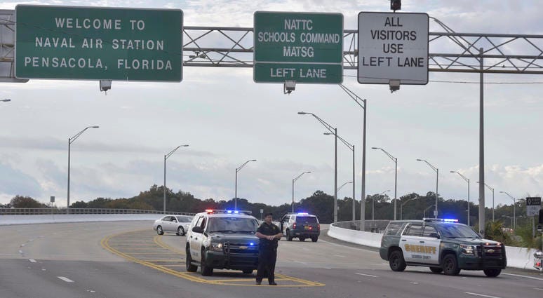 Police vehicles block the entrance to the Pensacola Air Base, Friday, Dec. 6, 2019 in Pensacola, Fla. Pensacola shooting