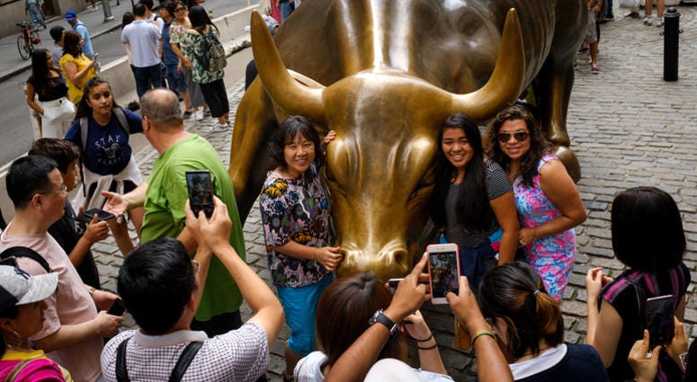 Tourists with Charging Bull Statue Tourists with Charging Bull Statue