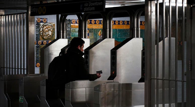 A customer swipes her metro card as she moves through the turnstiles at the Fulton Center subway station, February 27, 2019 in New York City. MTA MetroCard subway