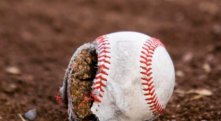 Worn out baseball laying in dirt Old Baseball Field