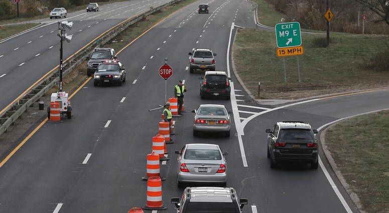 In the aftermath of Superstorm Sandy, New York State Police restrict traffic on Meadowbrook Parkway to residents of Long Beach and adjoining areas on November 2, 2012 in Freeport, New York. Meadowbrook Parkway