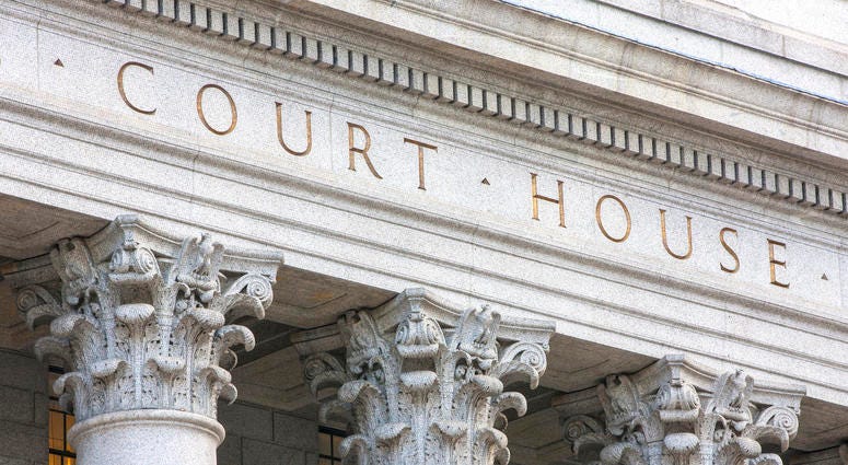 Facade of courthouse with columns. Court house (getty)