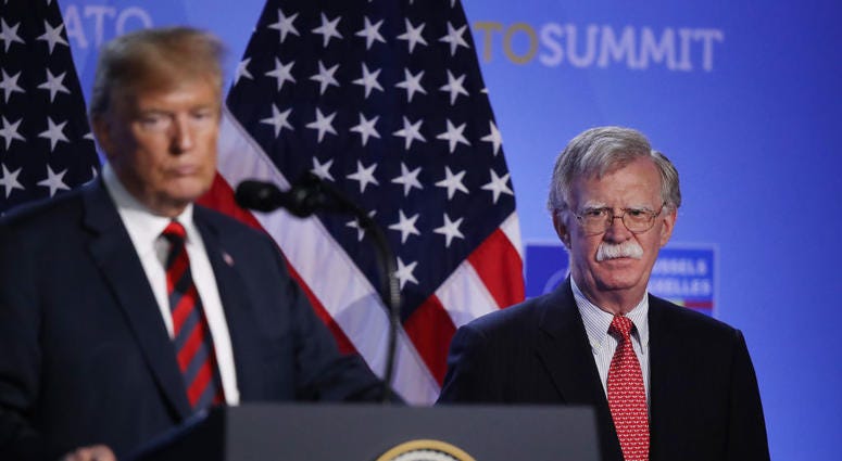 U.S. President Donald Trump, flanked by National Security Advisor John Bolton, speaks to the media at a press conference on the second day of the 2018 NATO Summit on July 12, 2018 in Brussels, Belgium. Trump and John Bolton