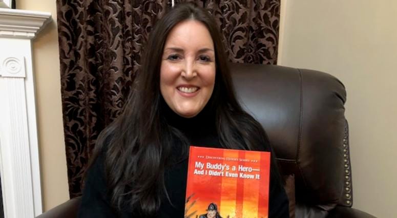 Kristie Kiernan Bouryal holds her book "My Buddy's a Hero And I Didn't Even Know It" Kristie Kiernan Bouryal
