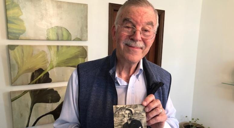 Bob Abate holds a photo of one of his interview subjects in his home on Nov. 8, 2019. Bob Abate
