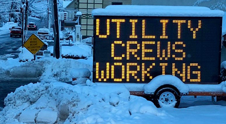 Utility crews working sign in New Jersey after snowstorm Utility crews working sign