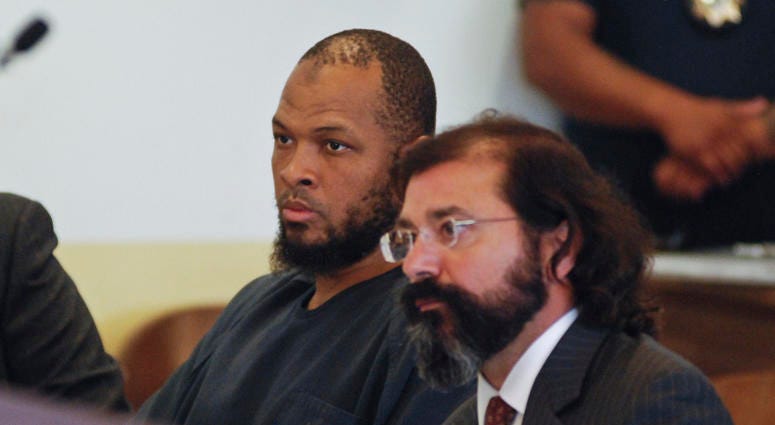 Siraj Ibn Wahhaj, left, sits next to public defense attorney Aleks Kostich at a first appearance in New Mexico state district court in Taos, N.M., Wednesday, Aug. 8, 2018, on accusations of child abuse and abducting his son from the boy's mother. Siraj Wahhaj