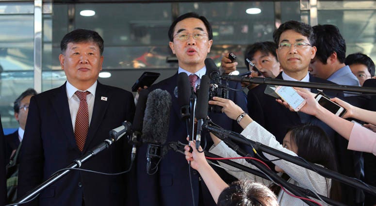 South Korean Unification Minister Cho Myoung-gyon, center, speaks to the media before leaving for the border village of Panmunjom to attend South and North Korean meeting, at the Office of the South Korea-North Korea Dialogue in Seoul, South Korea. South Korean Unification Minister