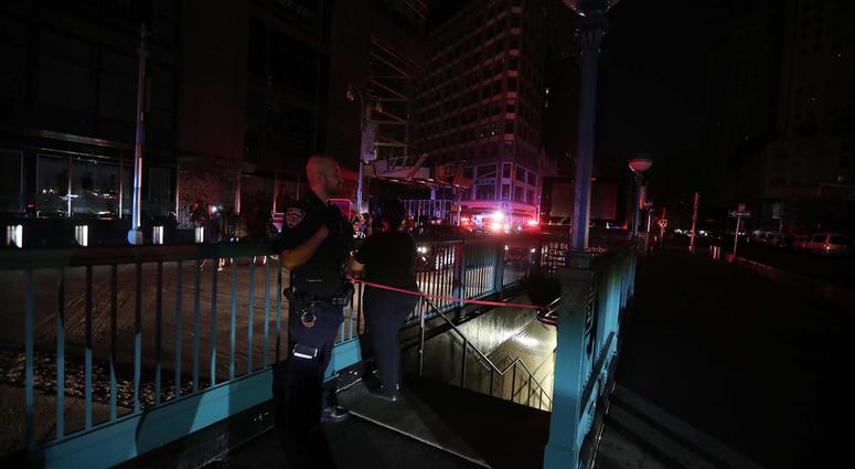 A member of the NYPD stands by a closed subway station at Columbus Circle in Manhattan was closed as subways were shut down after a power outage left large parts of the West Side of Manhattan without power July 13, 2019. NYC Blackout 2019