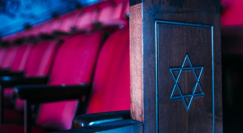 An interior view of a pew with red seats and a star in a Jewish synagogue in New York Jewish synagogue