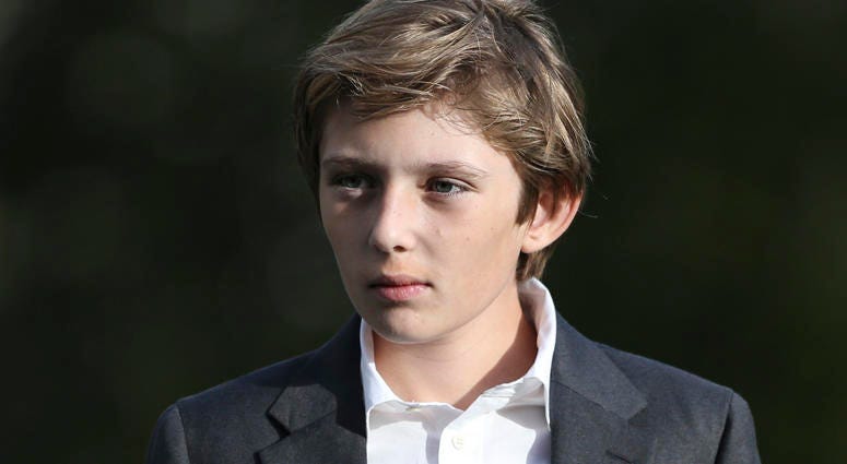 Barron Trump waits for President Donald Trump while he speaks to reporter on the South Portico of the White House in Washington D.C., on November 21, 2017. Barron Trump