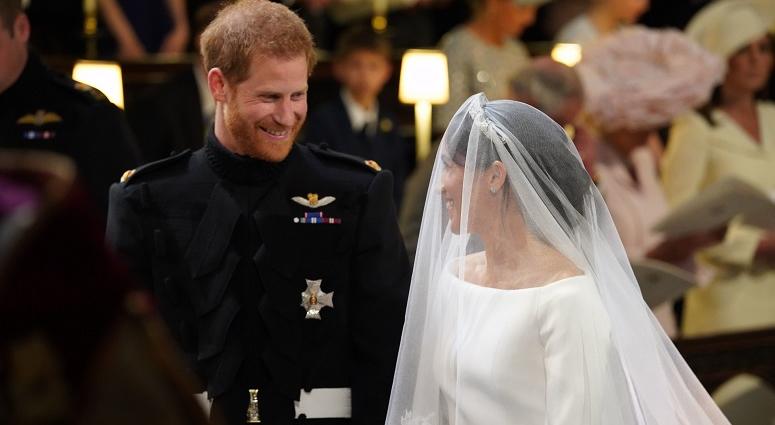 Prince Harry looks at his bride, Meghan Markle, as she arrives accompanied by the Prince of Wales in St George's Chapel at Windsor Castle for their wedding. The Royal Wedding