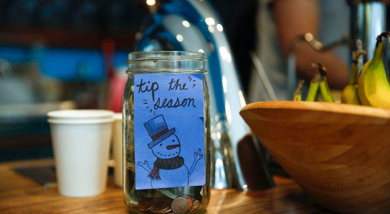 A tip jar at a Dollop coffee shop in the Streeterville neighborhood in Chicago on Thursday, Nov. 29, 2018. Tip Jar