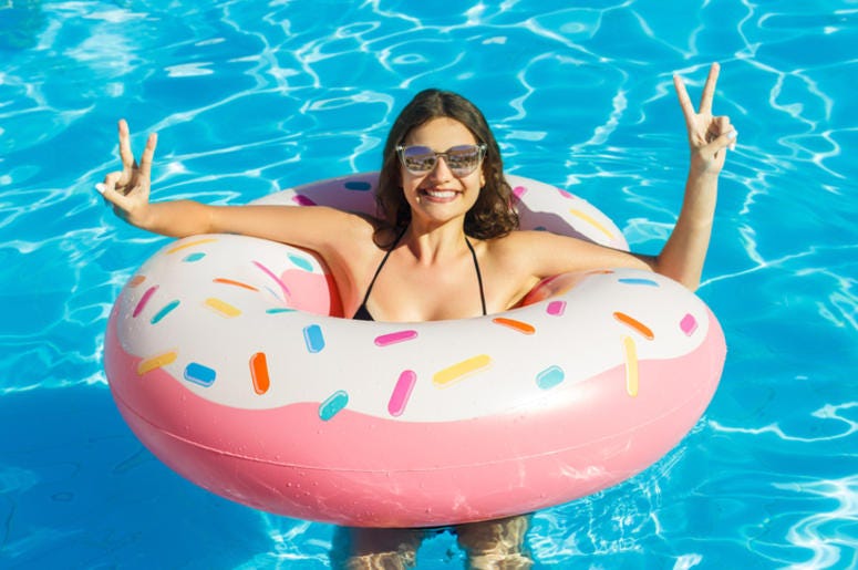 Woman in a pool using a donut float