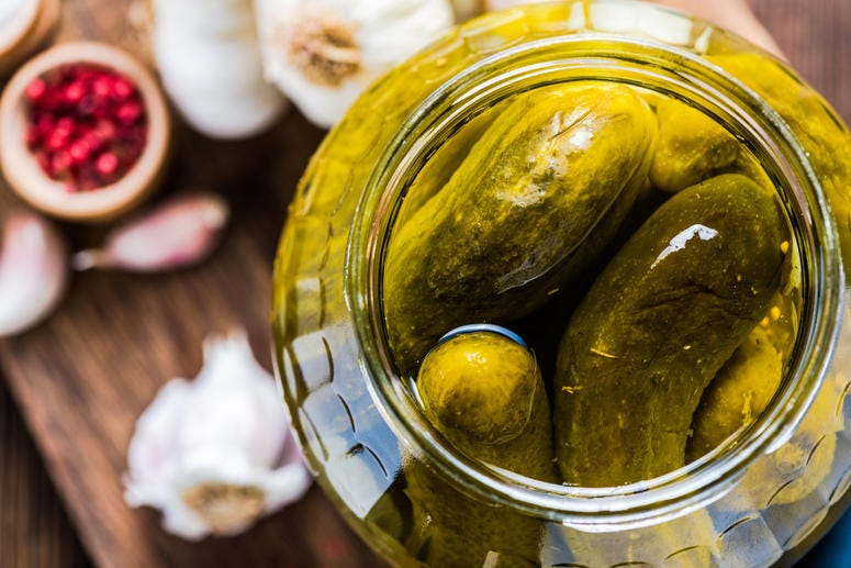 Pickles in a jar on a table