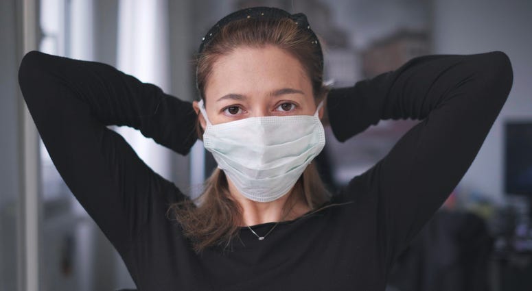 woman wearing surgical mask for coronavirus isolation Woman wearing surgical mask for coronavirus isolation
