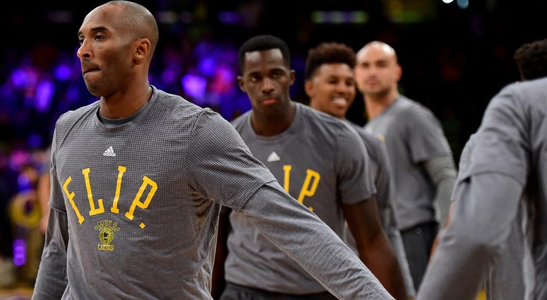 Kobe Bryant #24 of the Los Angeles Lakers and the Los Angeles Lakers team wear t-shirts to honor the passing of Philip "Flip" Saunders before the game against the Minnesota Timberwolves at Staples Center on October 28, 2015 in Los Angeles, California. Kobe Bryant #24 of the Los Angeles Lakers and the Los Angeles Lakers team wear t-shirts to honor the passing of Philip "Flip" Saunders before the game against the Minnesota Timberwolves at Staples Center on October 28, 2015 in Los Angeles, California.