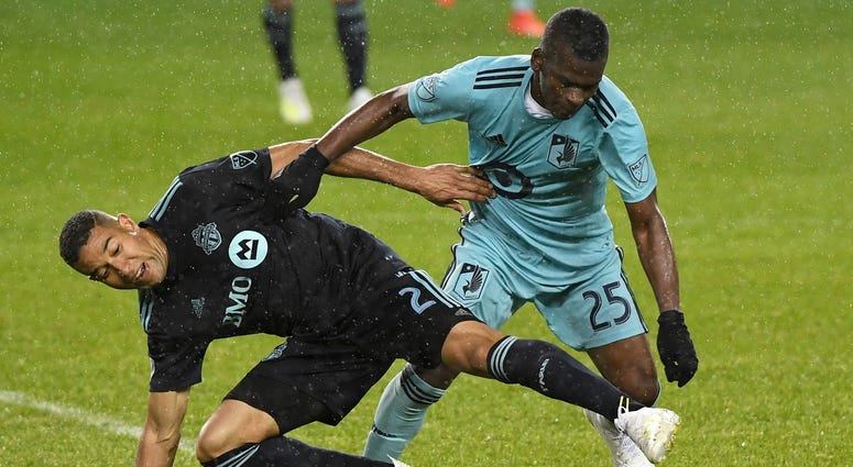 Darwin Quintaro and Justin Morrow and the soccer ball Darwin Quintaro of the Loons