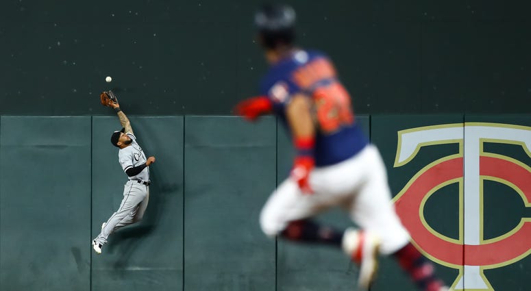 Sep 18, 2019; Minneapolis, MN, USA; Chicago White Sox right fielder Leury Garcia (28) leaps but cannot catch a double hit by Minnesota Twins right fielder Eddie Rosario (20) in the eighth inning at Target Field.