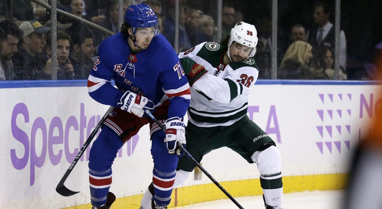 Mats Zuccarello battles with Filip Chytil Mats Zuccarello and Filip Chytil and the puck