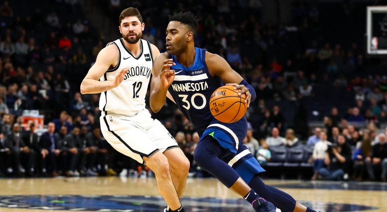 Joe Harris tries to guard Kelan Martin of the Timberwolves Kelan Martin and Joe Harris