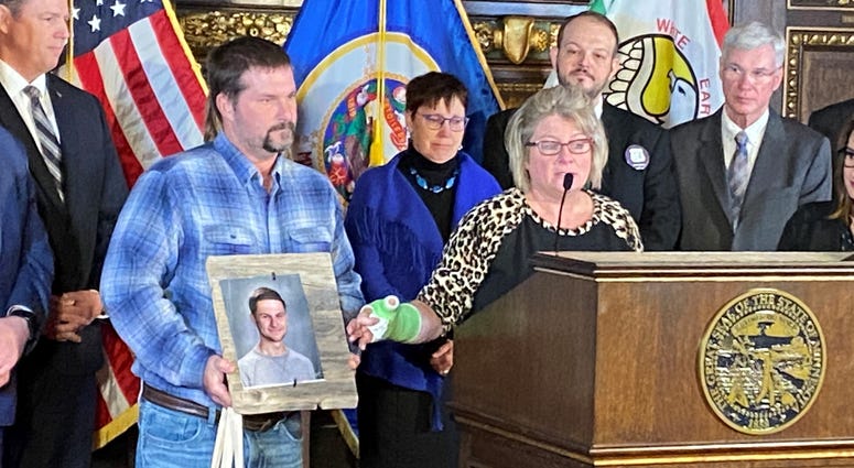 Michele Gran points to a picture of her son, Landon