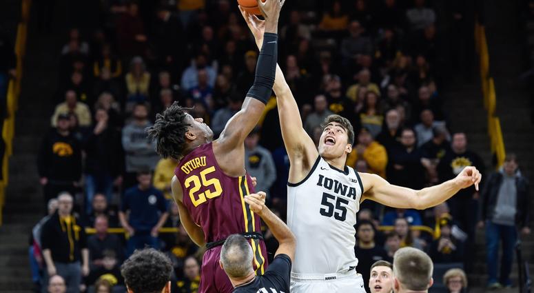 Iowa center Luka Garza jumps against Gopher center Daniel Oturu Gophers center Daniel Oturu faces Iowa center Luka Garza