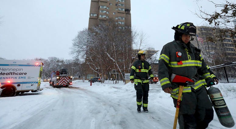 Firefights at the scene of the high rise fire in Minneapolis