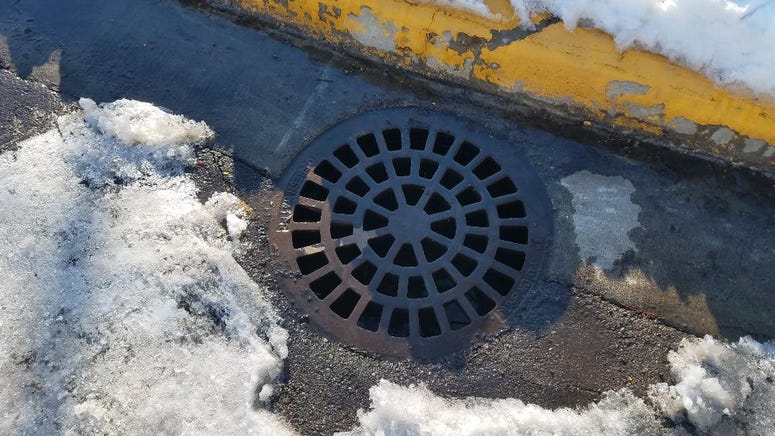 Water going down storm drain Storm drain doing its work