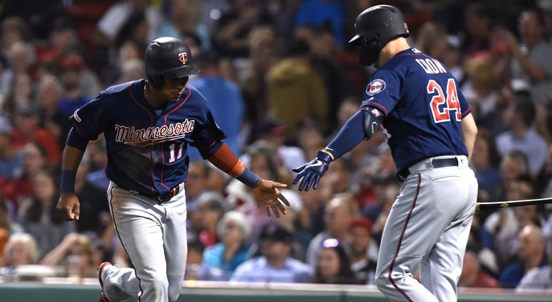 Sep 3, 2019; Boston, MA, USA; Minnesota Twins shortstop Jorge Polanco (11) is congratulated by first baseman C.J. Cron (24) after scoring a run against the Boston Red Sox during the third inning at Fenway Park.