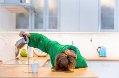 Tired Woman Trying To Pour Coffee