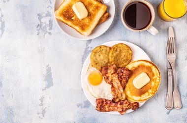 Healthy Full American Breakfast with Eggs Bacon Pancakes and Latkes