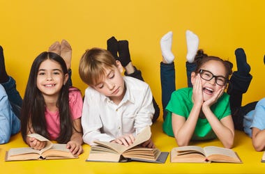 Children lying on floor and reading books