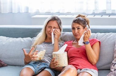 Two Women Crying While Watching A Move