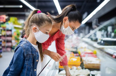 Woman and Child Masked Choosing Groceries